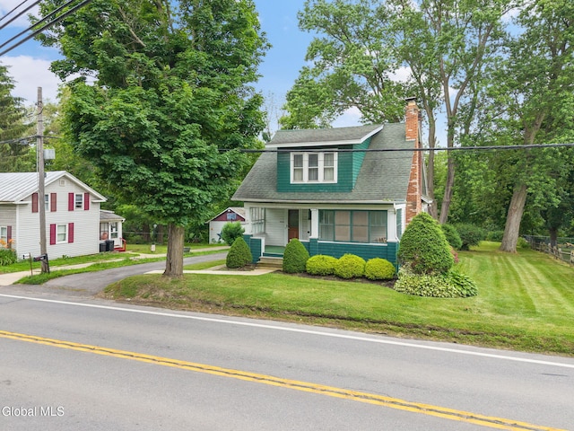 1659 State Route 7, Cobleskill, NY 12043 - colonial inspired home with a porch, a chimney, a front lawn, and a shingled roof