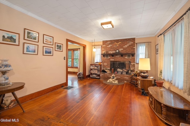 1659 State Route 7, Cobleskill, NY 12043 - living room with healthy amount of natural light, hardwood / wood-style flooring, ornamental molding, and a brick fireplace