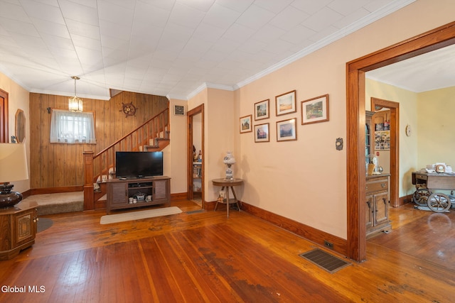 1659 State Route 7, Cobleskill, NY 12043 - living area with wood-type flooring, stairway, wood walls, and ornamental molding