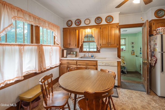1659 State Route 7, Cobleskill, NY 12043 - kitchen with white appliances, crown molding, light countertops, a ceiling fan, and brown cabinets
