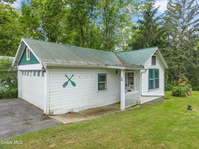 1659 State Route 7, Cobleskill, NY 12043 - view of front of home featuring a metal roof, a front lawn, and a garage