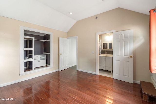 654 Sand Creek Rd, Colonie, NY 12205 - unfurnished bedroom featuring lofted ceiling, wood finished floors, and ensuite bath