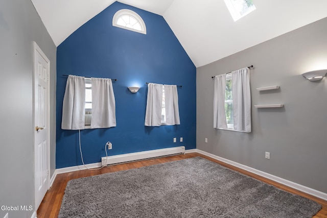 654 Sand Creek Rd, Colonie, NY 12205 - unfurnished bedroom featuring a baseboard heating unit, a skylight, wood finished floors, and high vaulted ceiling