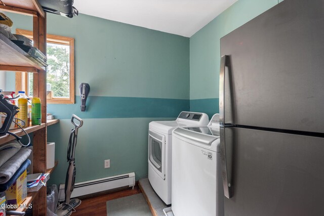 654 Sand Creek Rd, Colonie, NY 12205 - laundry area with baseboard heating, washing machine and clothes dryer, and wood finished floors