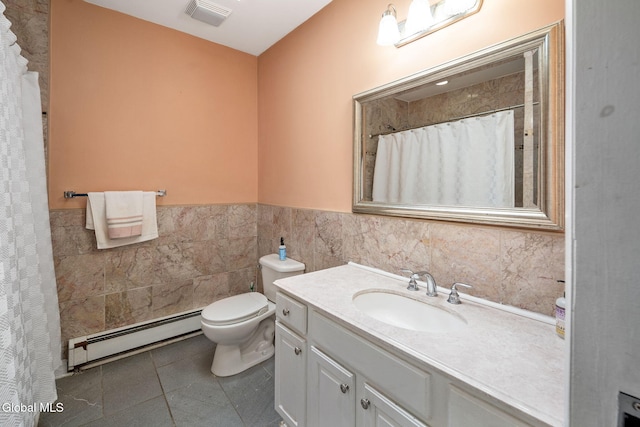 654 Sand Creek Rd, Colonie, NY 12205 - full bathroom with a baseboard heating unit, vanity, tile walls, a wainscoted wall, and tile patterned flooring