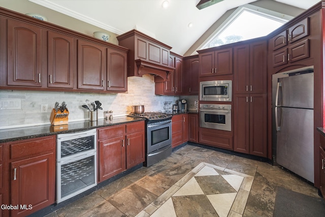 654 Sand Creek Rd, Colonie, NY 12205 - kitchen with stainless steel appliances, tasteful backsplash, stone tile floors, dark stone counters, and lofted ceiling