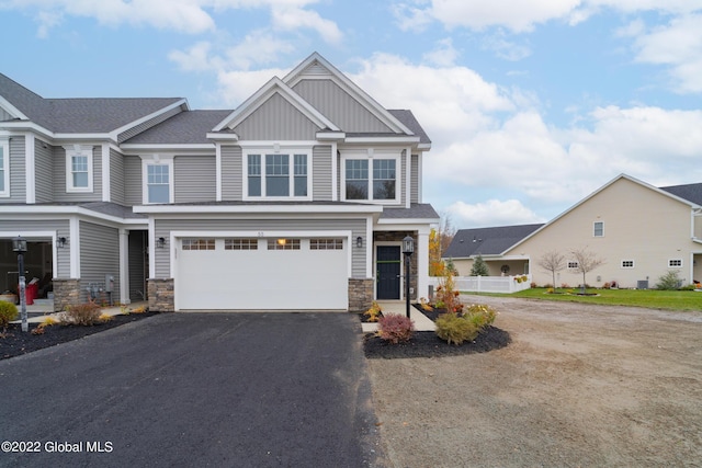 47 Priddle Ln, Colonie, NY 12110 - view of front of house with asphalt driveway, stone siding, board and batten siding, and a garage