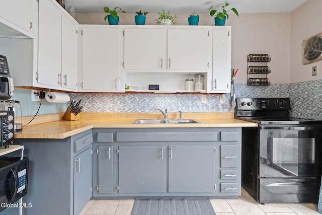 27 Terry Ave, Guilderland, NY 12303 - kitchen with black appliances, light tile patterned floors, backsplash, light countertops, and open shelves