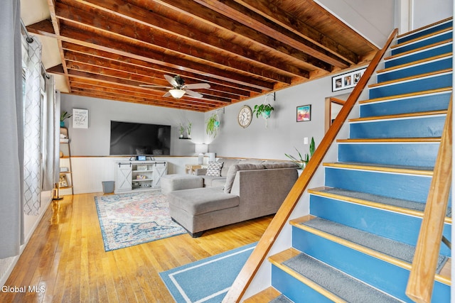 27 Terry Ave, Guilderland, NY 12303 - living area featuring stairway, a ceiling fan, hardwood / wood-style floors, and a wainscoted wall