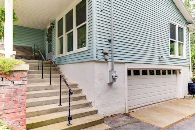 909 Ash Tree Ln, Niskayuna, NY 12309 - view of property exterior featuring an attached garage, stairway, and driveway