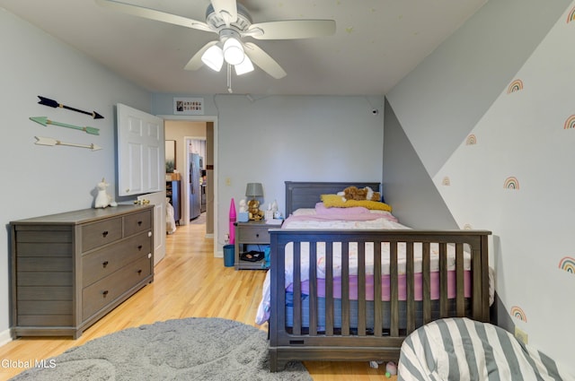 909 Ash Tree Ln, Niskayuna, NY 12309 - bedroom with light wood-style floors, ceiling fan, and stainless steel fridge with ice dispenser