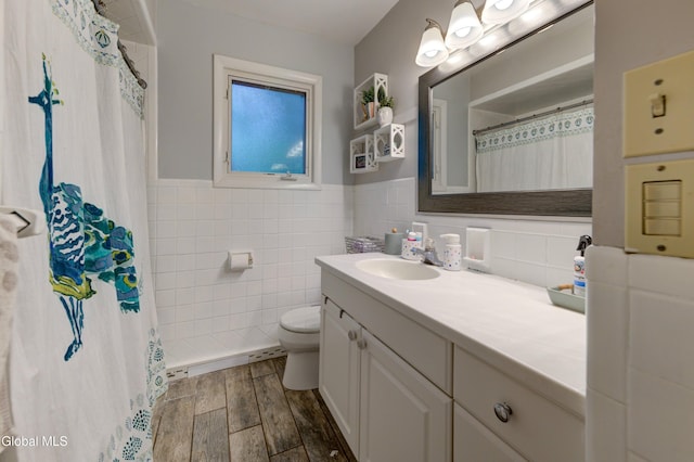 909 Ash Tree Ln, Niskayuna, NY 12309 - full bathroom with vanity, wood finished floors, tile walls, wainscoting, and curtained shower