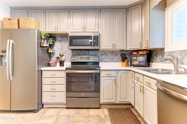909 Ash Tree Ln, Niskayuna, NY 12309 - kitchen with appliances with stainless steel finishes, light countertops, and backsplash