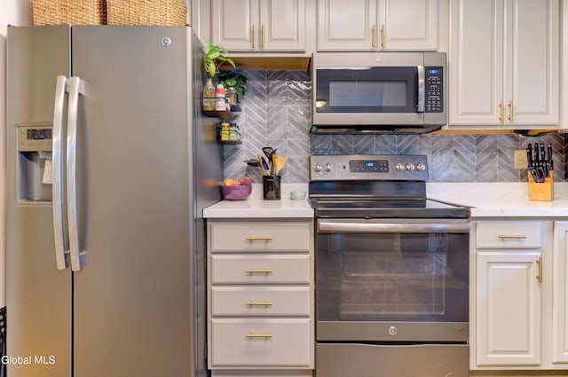 909 Ash Tree Ln, Niskayuna, NY 12309 - kitchen featuring stainless steel appliances, decorative backsplash, and white cabinets