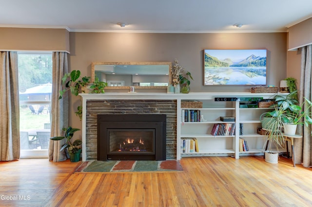 909 Ash Tree Ln, Niskayuna, NY 12309 - living area with wood finished floors, ornamental molding, and a stone fireplace