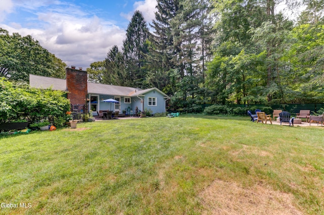909 Ash Tree Ln, Niskayuna, NY 12309 - view of grassy yard with a patio and a fire pit
