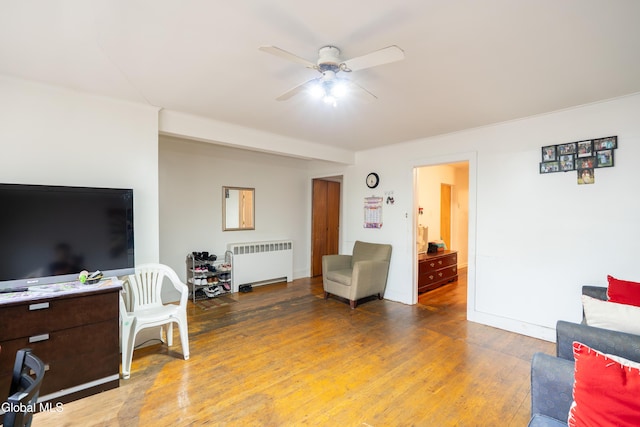 8-10 Spruce St, Rensselaer, NY 12144 - living area featuring radiator, a ceiling fan, and wood finished floors