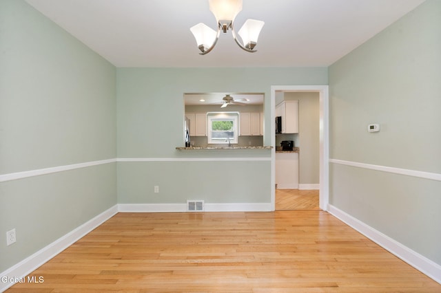 1226 Sumner Ave, Schenectady, NY 12309 - empty room with a chandelier and light wood-type flooring