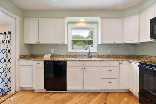 1226 Sumner Ave, Schenectady, NY 12309 - kitchen featuring black appliances, white cabinets, light wood-type flooring, and light stone countertops