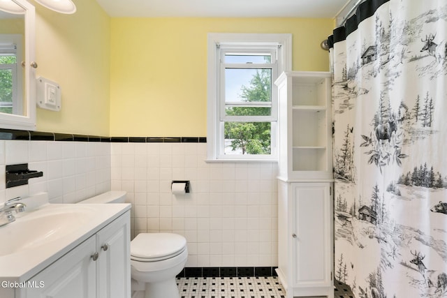 1226 Sumner Ave, Schenectady, NY 12309 - full bathroom with tile walls, vanity, a wainscoted wall, healthy amount of natural light, and tile patterned floors