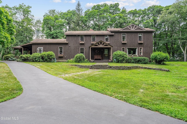 135 Willow St, Guilderland, NY 12084 - view of front facade featuring a front yard, asphalt driveway, and view of scattered trees