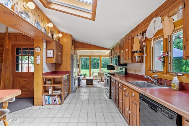 135 Willow St, Guilderland, NY 12084 - kitchen featuring black appliances, lofted ceiling, and brown cabinetry