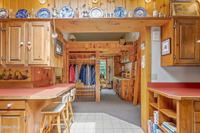 135 Willow St, Guilderland, NY 12084 - kitchen with light carpet, light countertops, and wood walls