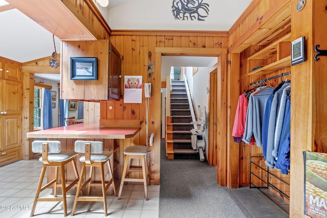 135 Willow St, Guilderland, NY 12084 - dining area with wooden walls, stairway, and vaulted ceiling