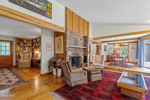 135 Willow St, Guilderland, NY 12084 - living room with a brick fireplace, healthy amount of natural light, light wood-style flooring, and high vaulted ceiling