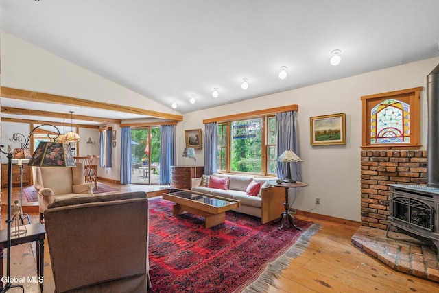 135 Willow St, Guilderland, NY 12084 - living area with a wood stove, light wood-style floors, and vaulted ceiling