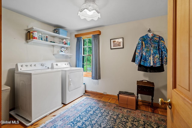 135 Willow St, Guilderland, NY 12084 - laundry area featuring washer and dryer, a chandelier, and light wood-style floors