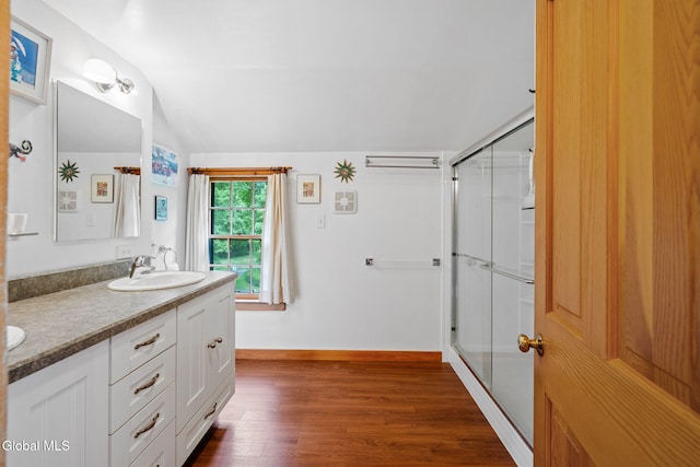 135 Willow St, Guilderland, NY 12084 - bathroom featuring wood finished floors, a stall shower, double vanity, and lofted ceiling