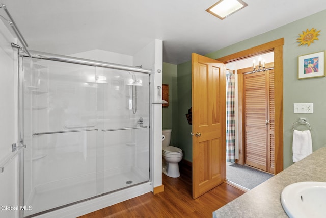 135 Willow St, Guilderland, NY 12084 - bathroom with a stall shower, wood finished floors, vanity, and a chandelier