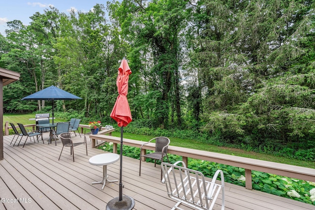 135 Willow St, Guilderland, NY 12084 - wooden deck with outdoor dining space, a lawn, view of scattered trees, and grilling area