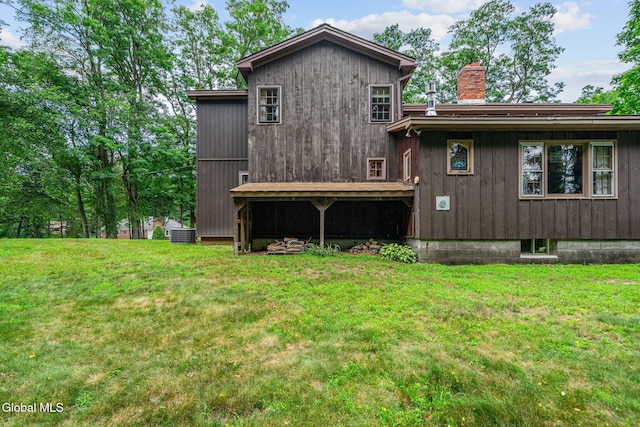 135 Willow St, Guilderland, NY 12084 - back of house featuring a chimney and a yard