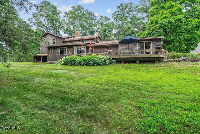 135 Willow St, Guilderland, NY 12084 - rear view of property featuring a chimney, a wooden deck, and a yard