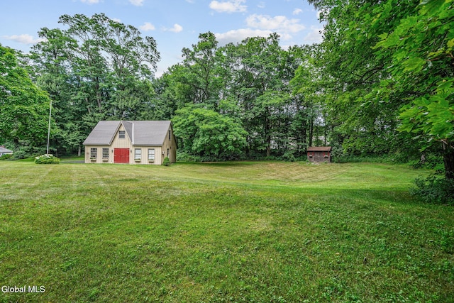 135 Willow St, Guilderland, NY 12084 - view of green lawn with an outbuilding and a detached garage