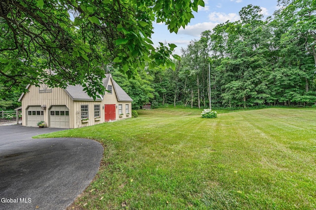 135 Willow St, Guilderland, NY 12084 - view of grassy yard with a garage