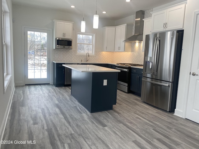 3 Priddle Ln, Colonie, NY 12110 - kitchen featuring wall chimney exhaust hood, stainless steel appliances, a kitchen island, recessed lighting, and backsplash
