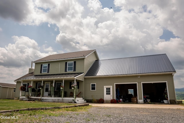 367 Buel Rd, Canajoharie, NY 13317 - back of house featuring a porch, a garage, a metal roof, and driveway