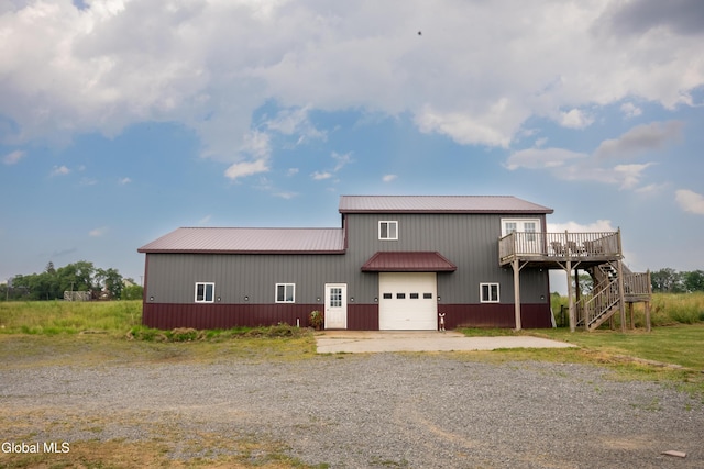 367 Buel Rd, Canajoharie, NY 13317 - rear view of house featuring a wooden deck, a metal roof, stairway, and driveway