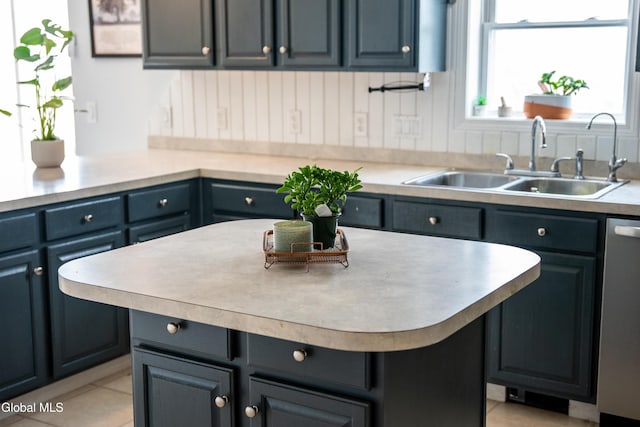 367 Buel Rd, Canajoharie, NY 13317 - kitchen featuring dishwasher, light countertops, a center island, and light tile patterned floors