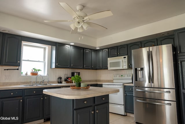 367 Buel Rd, Canajoharie, NY 13317 - kitchen with white appliances, light countertops, a ceiling fan, light tile patterned floors, and decorative backsplash