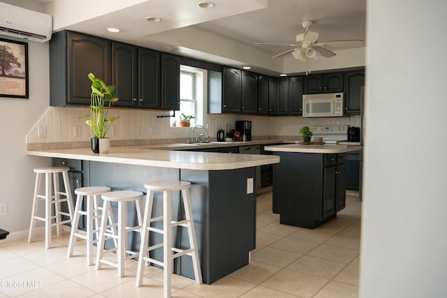 367 Buel Rd, Canajoharie, NY 13317 - kitchen featuring white microwave, a wall unit AC, tasteful backsplash, light countertops, and a peninsula