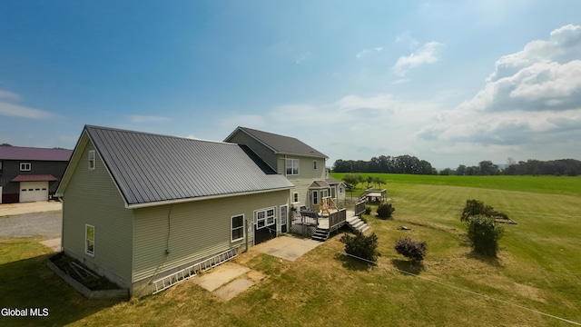 367 Buel Rd, Canajoharie, NY 13317 - rear view of house featuring a wooden deck, a metal roof, and a yard