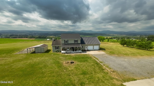 367 Buel Rd, Canajoharie, NY 13317 - view of front of house with driveway, a garage, a front lawn, and a metal roof