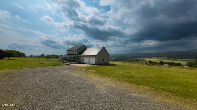 367 Buel Rd, Canajoharie, NY 13317 - view of property exterior with driveway, a lawn, an attached garage, and a metal roof