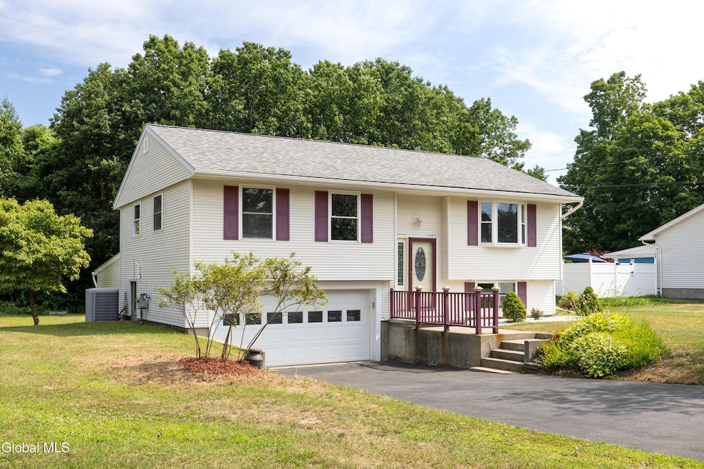 64 Feeder Dam Rd, Moreau, NY 12803 - bi-level home with a garage, asphalt driveway, a front yard, and roof with shingles