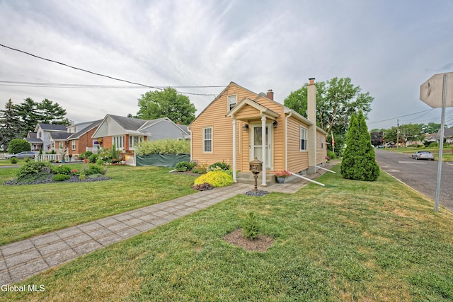 1752 Van Cortland St, Schenectady, NY 12303 - view of front of house with a chimney and a front yard