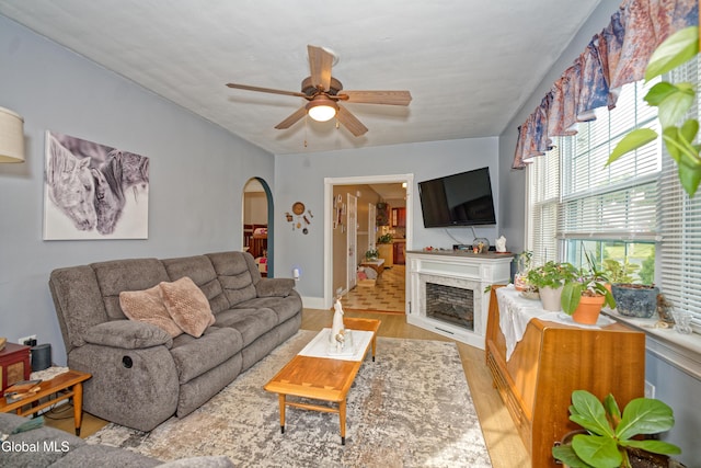 1752 Van Cortland St, Schenectady, NY 12303 - living room with arched walkways, ceiling fan, light wood-style flooring, and a fireplace